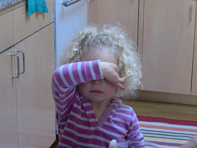 child covering face